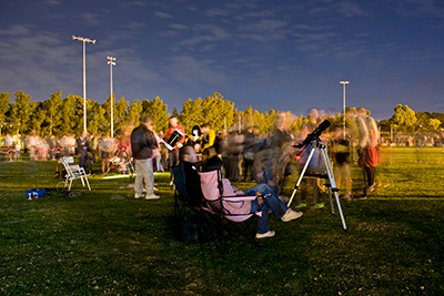 Visitors queue to view Saturn through a telescope at Astrofest 2012.