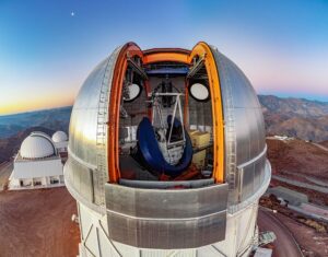 The Víctor M. Blanco 4-meter Telescope is surrounded by wide open skies of the Chilean Andes from its perch at Cerro Tololo Inter-American Observatory. To the upper left of the telescope is the ‘evening star’, actually the planet Venus. Below on the left are the SMARTS 1.5-meter Telescope and SMARTS 0.9-meter Telescope (furthest back).