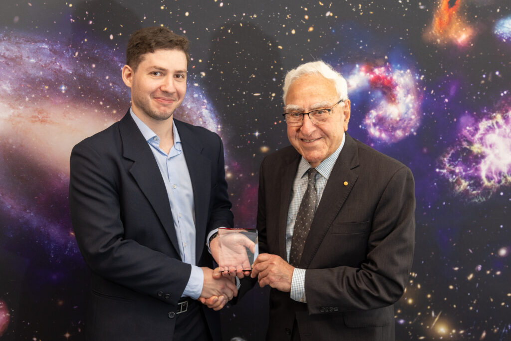 Dr Ken Michael presents the 2024 Ken and Julie Michael prize to ICRAR/UWA student Andrei Ristea